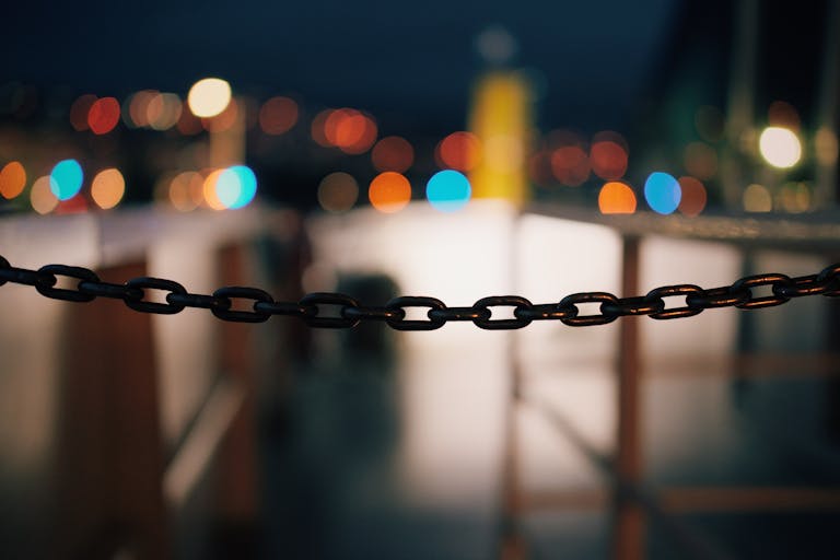 Focused chain with a vibrant bokeh effect in the background, shot at night.